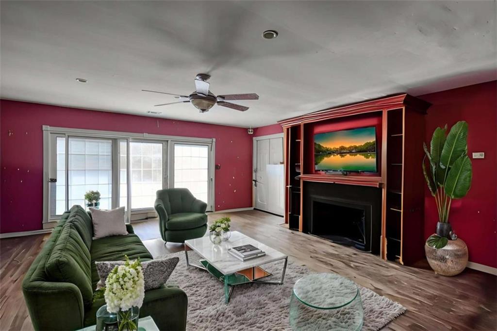 3588 Old Hamilton Mill Road Northeast Buford, GA 30519 - Photo 37 of 49 a living room with furniture a flat screen tv and a large window