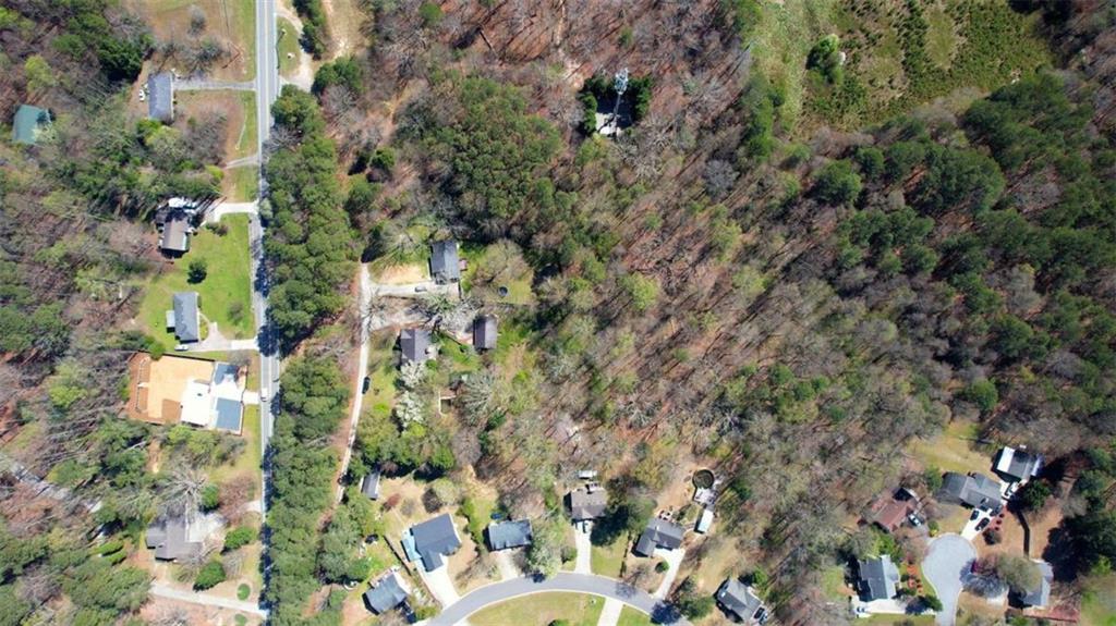 3588 Old Hamilton Mill Road Northeast Buford, GA 30519 - Photo 45 of 49 an aerial view of a house with a yard and covered with trees