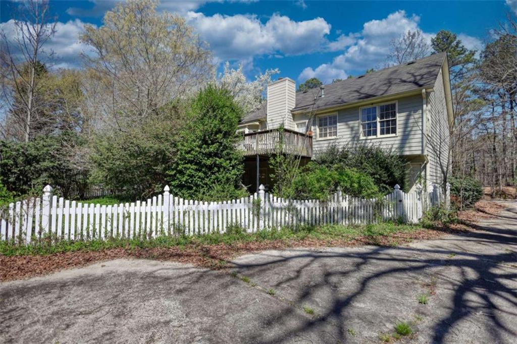 3588 Old Hamilton Mill Road Northeast Buford, GA 30519 - Photo 5 of 49 a front view of a house with a yard