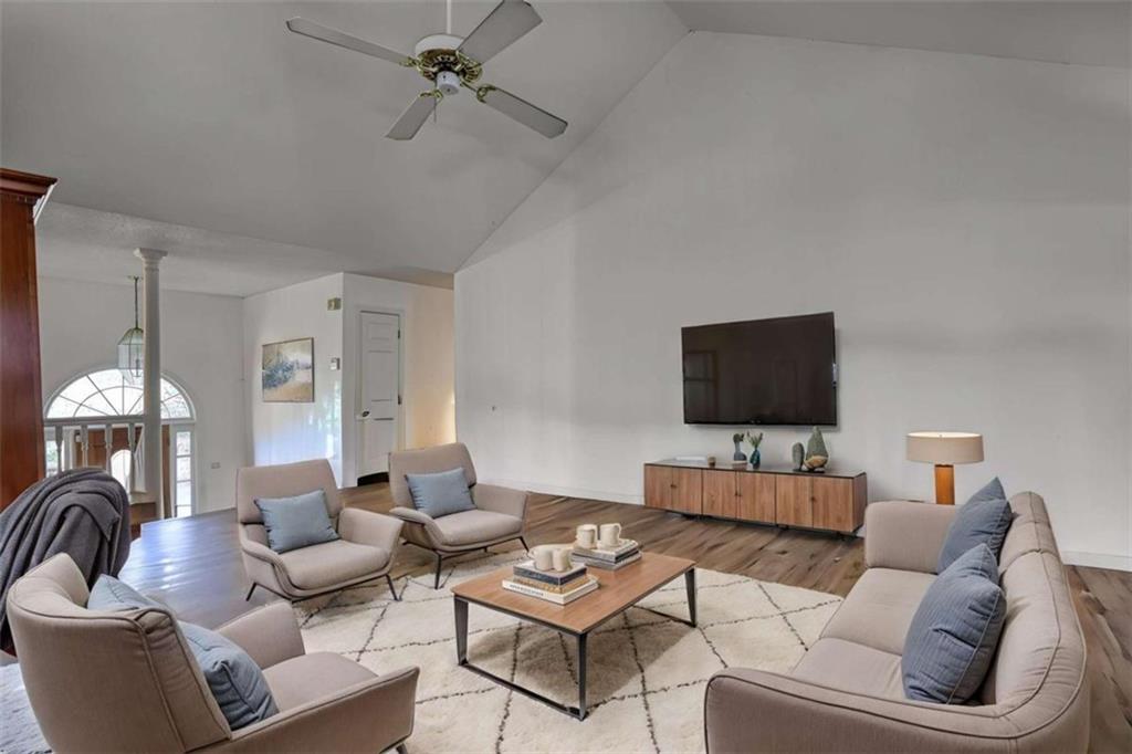 3588 Old Hamilton Mill Road Northeast Buford, GA 30519 - Photo 7 of 49 a living room with furniture a flat screen tv and a window