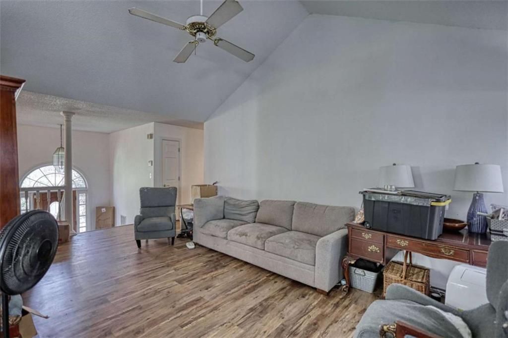 3588 Old Hamilton Mill Road Northeast Buford, GA 30519 - Photo 9 of 49 a living room with furniture and a chandelier