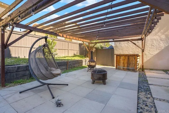 a view of a porch with chairs and a grill