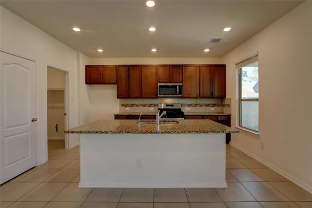 a kitchen with a stove a sink and a microwave