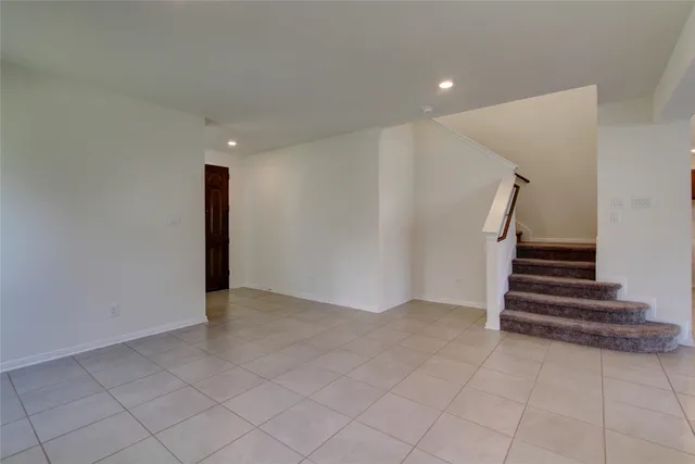 a view of an empty room with stairs