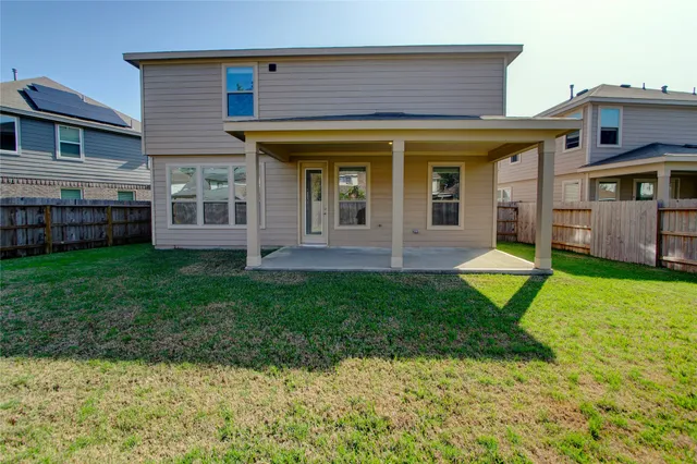 a view of a house with a yard and sitting area