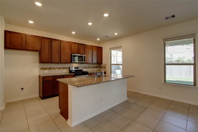 a large kitchen that has a lot of cabinets in it