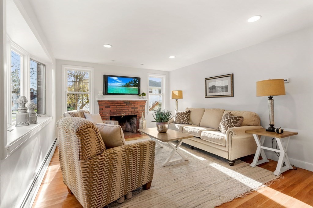 21 Albemarle Road Newton, MA 02460 - Photo 2 of 25 a living room with furniture a fireplace and a flat screen tv