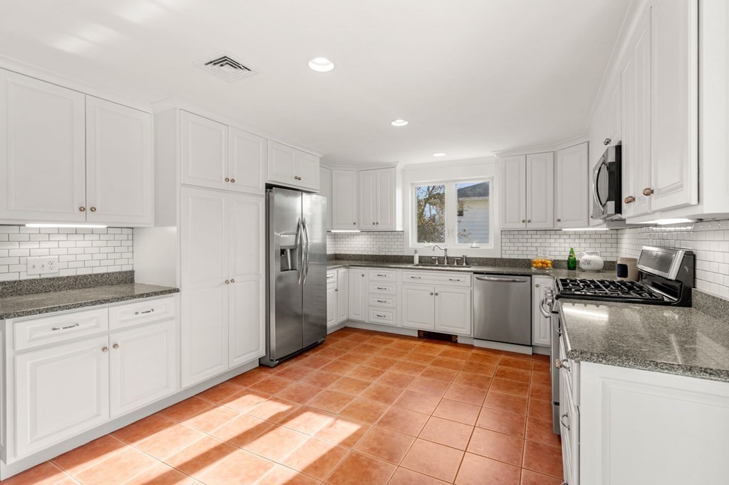 21 Albemarle Road Newton, MA 02460 - Photo 5 of 25 a kitchen with granite countertop white cabinets and stainless steel appliances