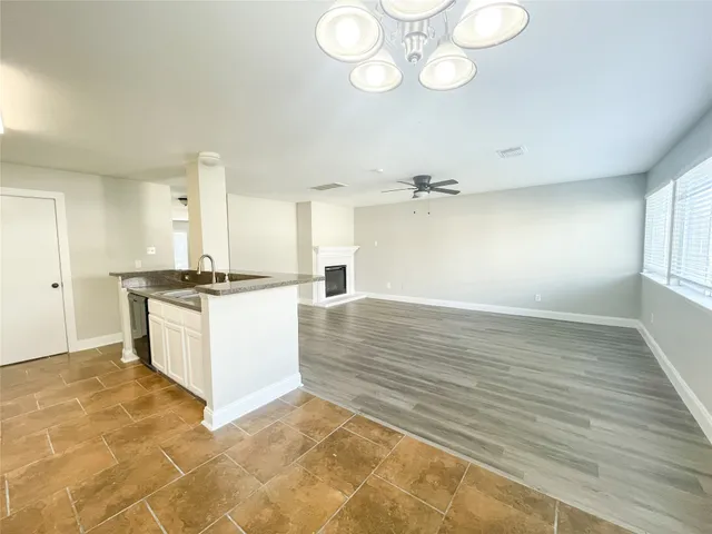 a view of kitchen with cabinets appliances and wooden floor