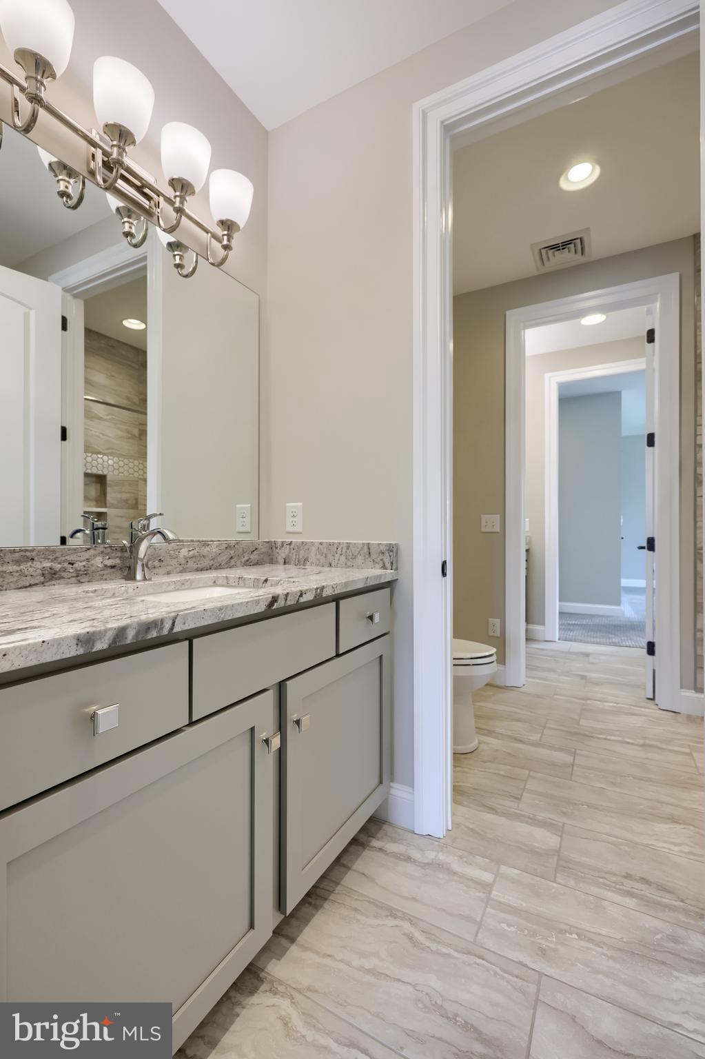 428 Southampton Drive Lititz, PA 17543 - Photo 52 of 60 a bathroom with a granite countertop sink a mirror and a shower