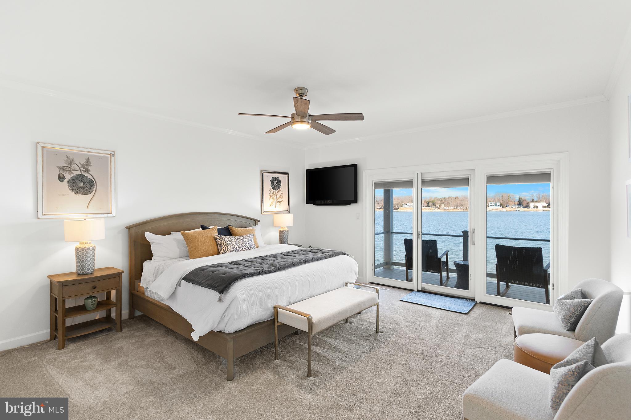 610 South River Landing Road Edgewater, MD 21037 - Photo 17 of 39 a spacious bedroom with a bed a couch and a fireplace