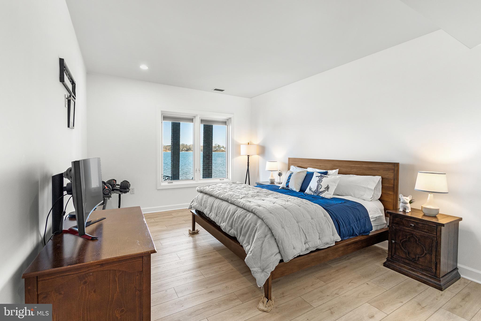 610 South River Landing Road Edgewater, MD 21037 - Photo 35 of 39 a bedroom with a bed and wooden floor