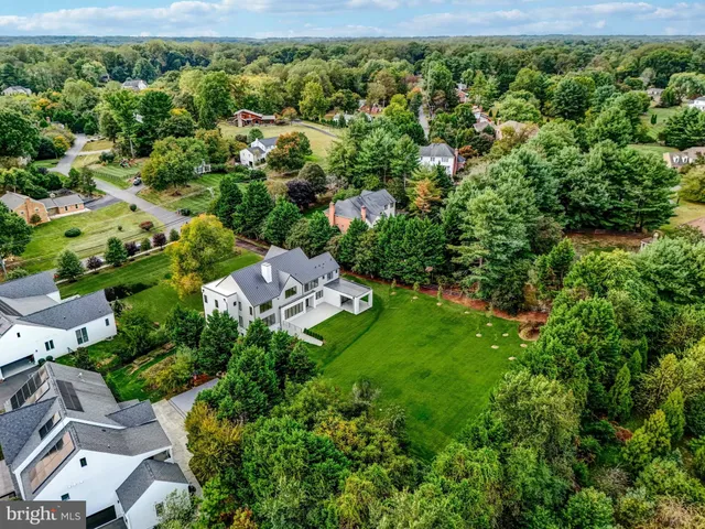 a bathroom with a double vanity sink a mirror and a bathtub
