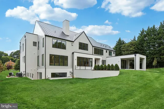 an aerial view of residential house with outdoor space and trees all around