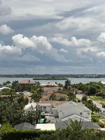 a large kitchen with granite countertop a large counter top space a sink stainless steel appliances and cabinets