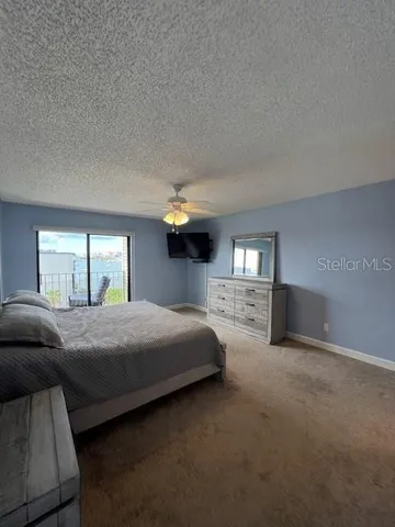 a view of a balcony with floor to ceiling windows with wooden floor