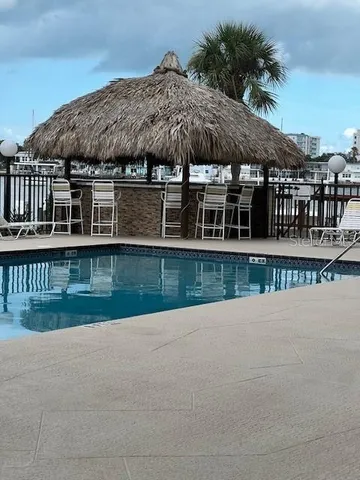 a view of a patio with table and chairs a barbeque with potted plants and big yard
