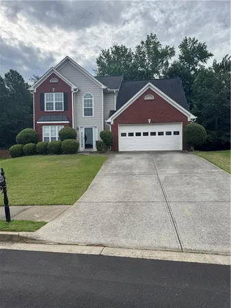 a front view of a house with a yard and garage