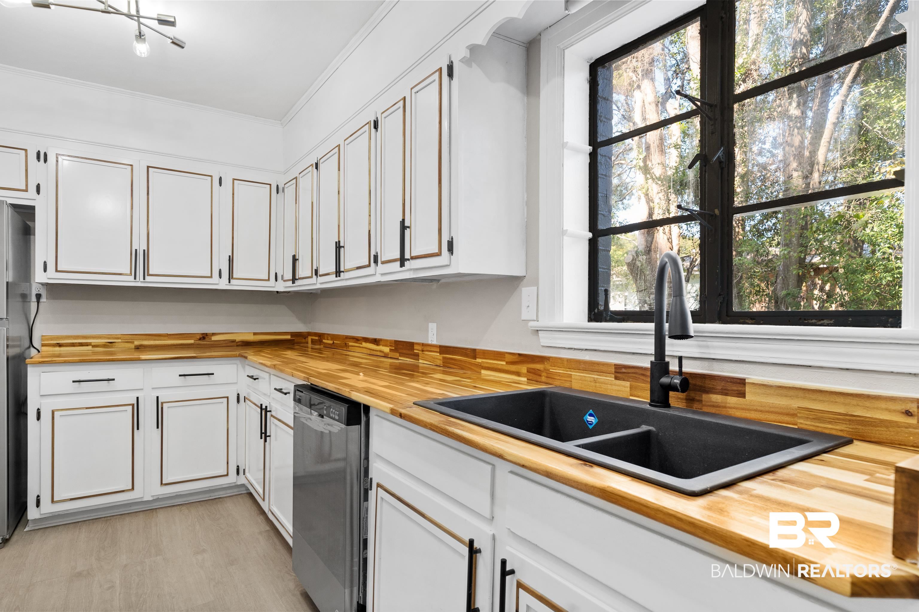 611 Morgan Avenue Mobile, AL 36606 - Photo 14 of 24 Kitchen featuring sink, white cabinetry, stainless steel dishwasher, wooden counters, and ornamental molding