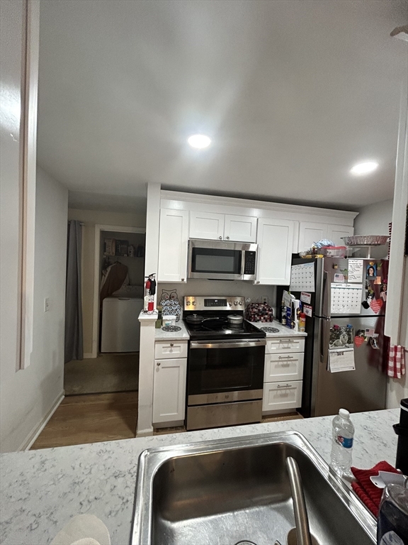 2205 Boston Road, Unit E43 Wilbraham, MA 01095 - Photo 12 of 22 a kitchen with stainless steel appliances a stove a sink and a refrigerator