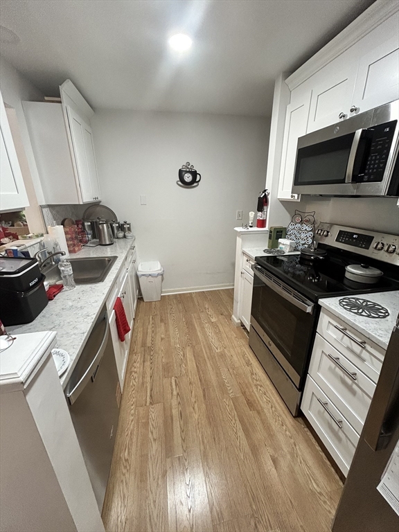 2205 Boston Road, Unit E43 Wilbraham, MA 01095 - Photo 13 of 22 a kitchen with a stove and a microwave