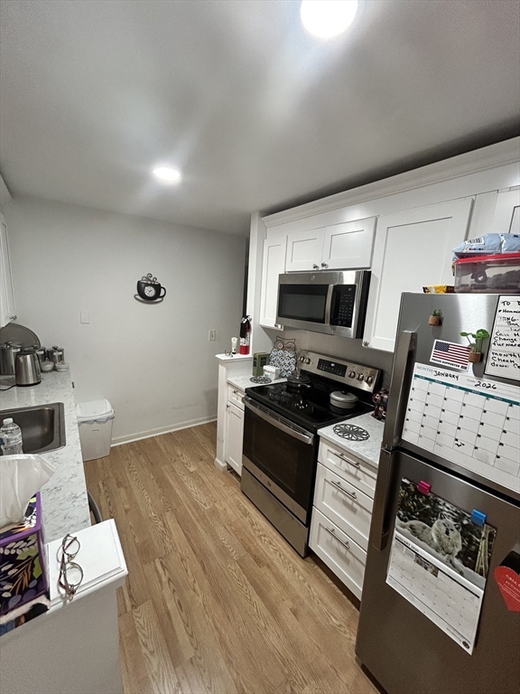 2205 Boston Road, Unit E43 Wilbraham, MA 01095 - Photo 14 of 22 a kitchen with granite countertop a stove and cabinets