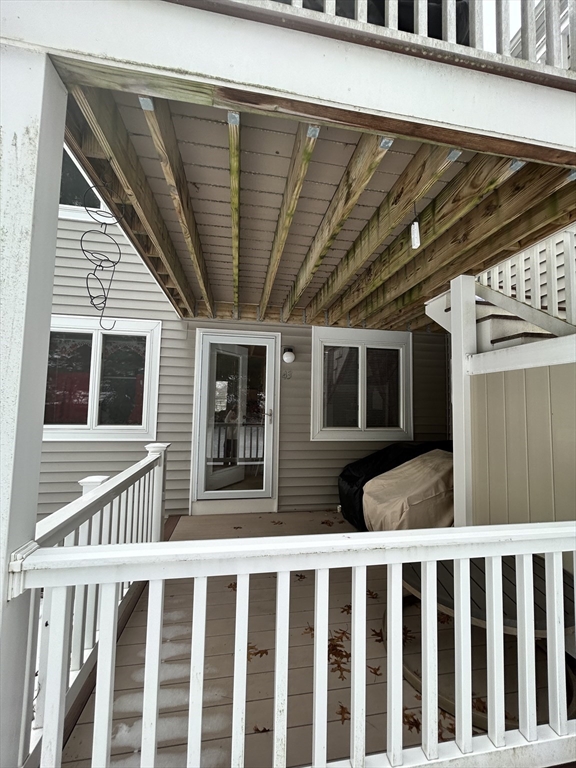 2205 Boston Road, Unit E43 Wilbraham, MA 01095 - Photo 17 of 22 a porch with a table and chairs