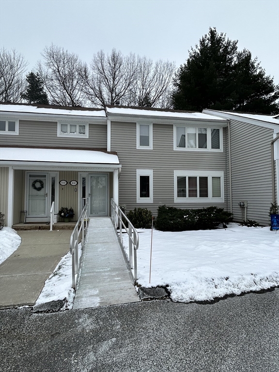 2205 Boston Road, Unit E43 Wilbraham, MA 01095 - Photo 2 of 22 a front view of a house with a yard covered with trees