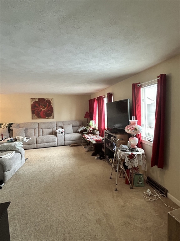 2205 Boston Road, Unit E43 Wilbraham, MA 01095 - Photo 5 of 22 a living room with furniture gym equipment and a flat screen tv
