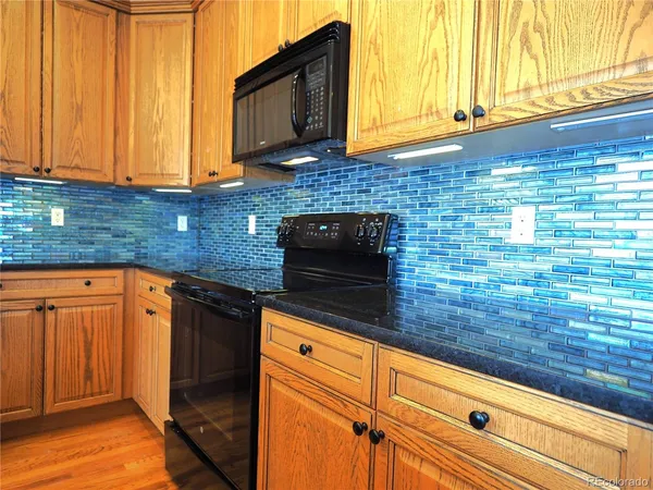 a kitchen with granite countertop a sink and a stove