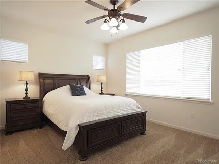 an empty room with closet and ceiling fan