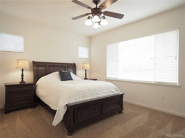 an empty room with closet and ceiling fan