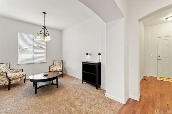 a living room with furniture and a chandelier