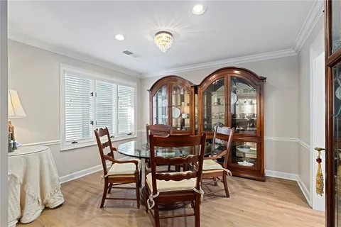 a kitchen with cabinets and wooden floor