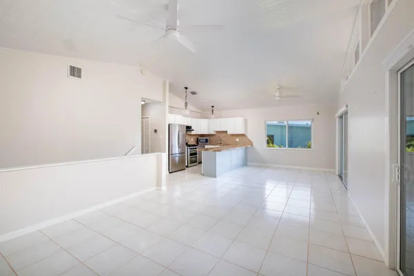 a kitchen with stainless steel appliances granite countertop a refrigerator a stove a sink and a refrigerator