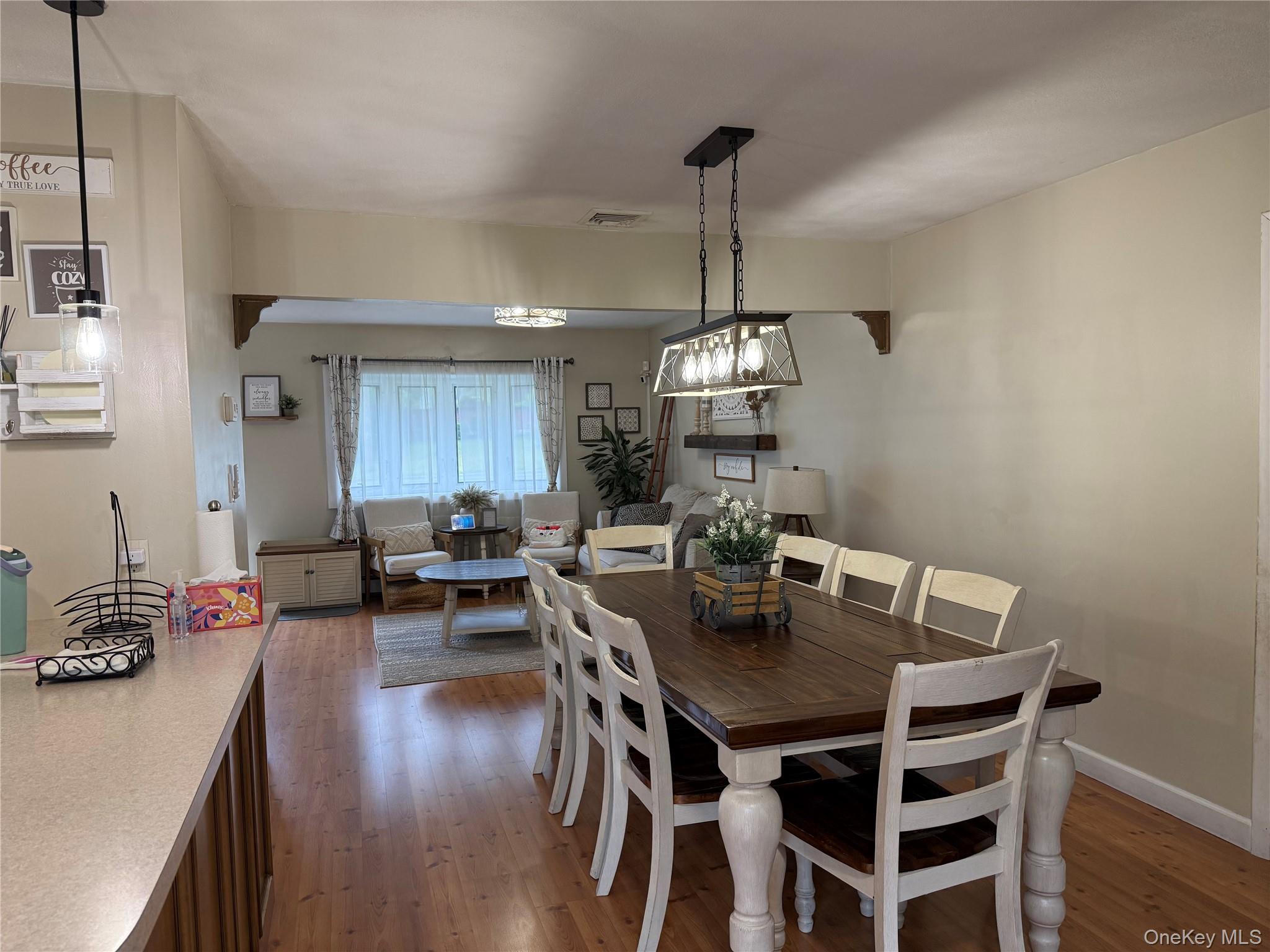 161 Hawkins Road Centereach, NY 11720 - Photo 6 of 16 a view of a dining room with furniture wooden floor and chandelier