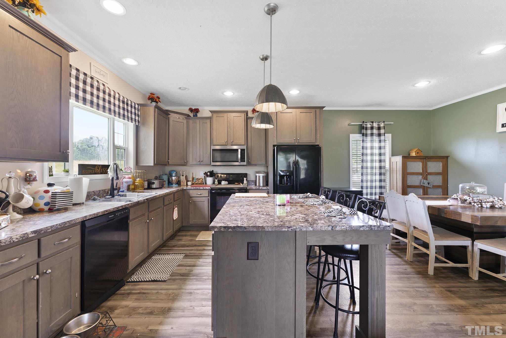 899 Dixon Road Coats, NC 27521 - Photo 8 of 21 a large kitchen with kitchen island a large island a sink a stove and a center island