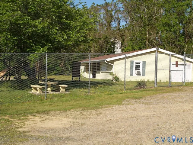 a view of a house with a yard and sitting area