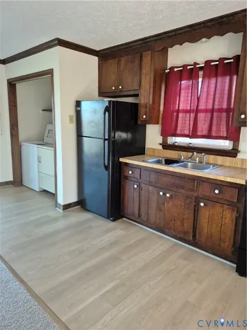 a kitchen with stainless steel appliances granite countertop a refrigerator stove and sink