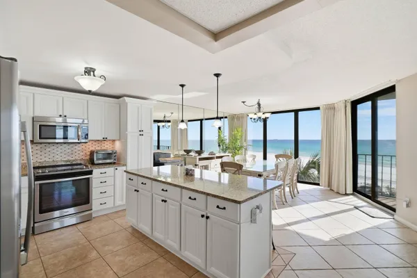 a kitchen with a sink stove and refrigerator