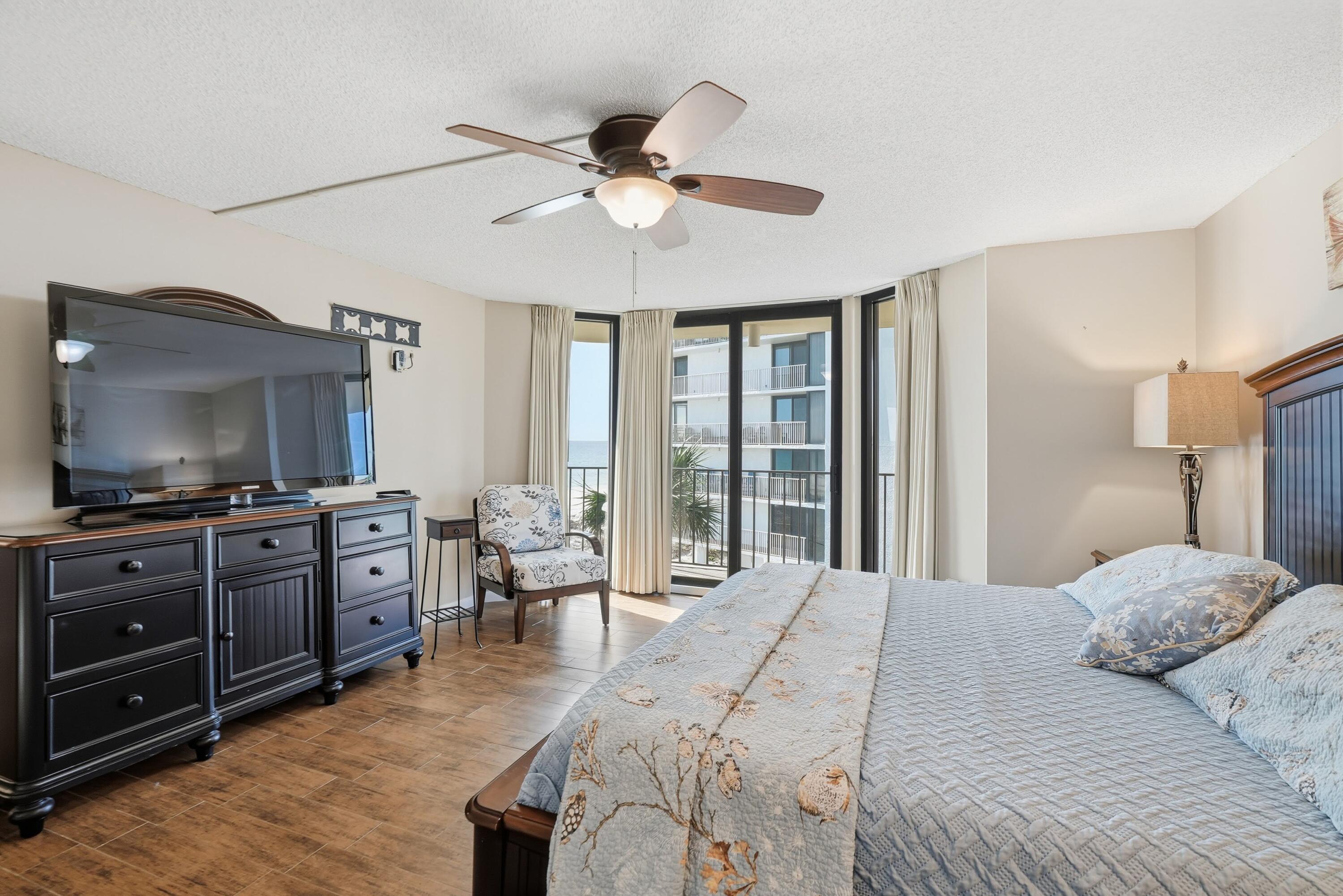 11619 Front Beach Road, Unit 212 Panama City Beach, FL 32407 - Photo 18 of 63 a bedroom with a bed and a flat screen tv