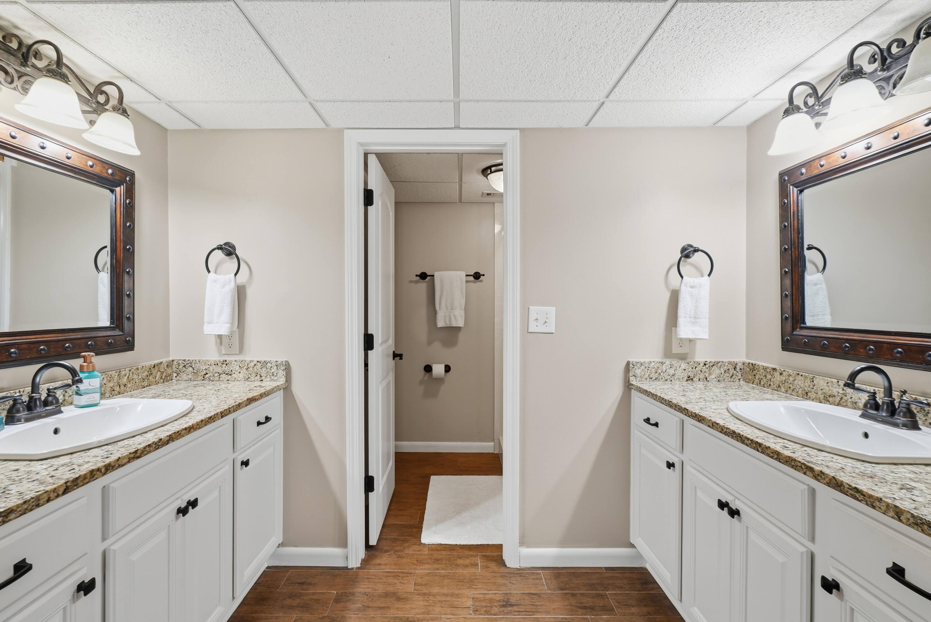 11619 Front Beach Road, Unit 212 Panama City Beach, FL 32407 - Photo 22 of 63 a bathroom with a double vanity sink and mirror with shower