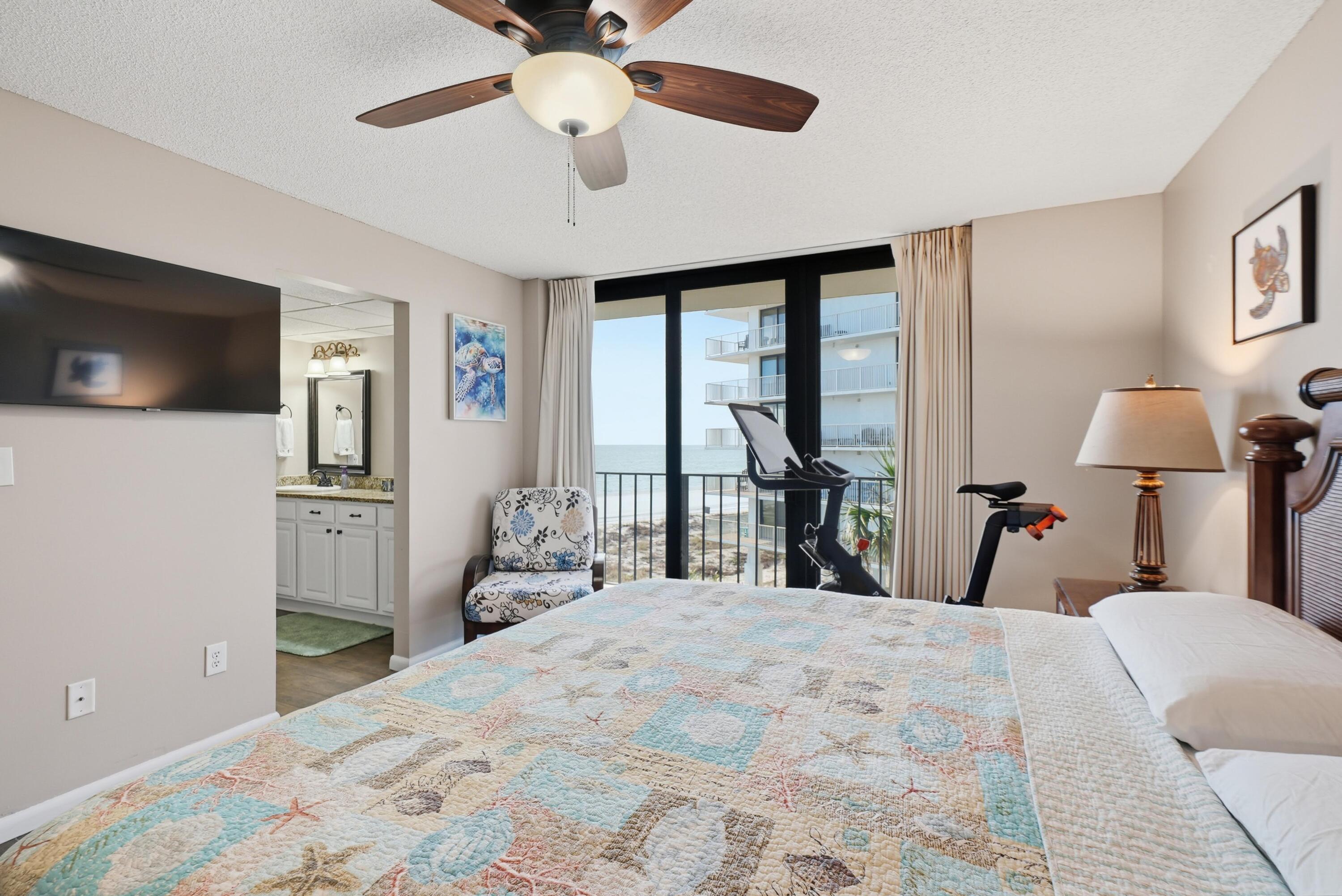 11619 Front Beach Road, Unit 212 Panama City Beach, FL 32407 - Photo 25 of 63 a bedroom with a bed and a flat tv screen on the dresser
