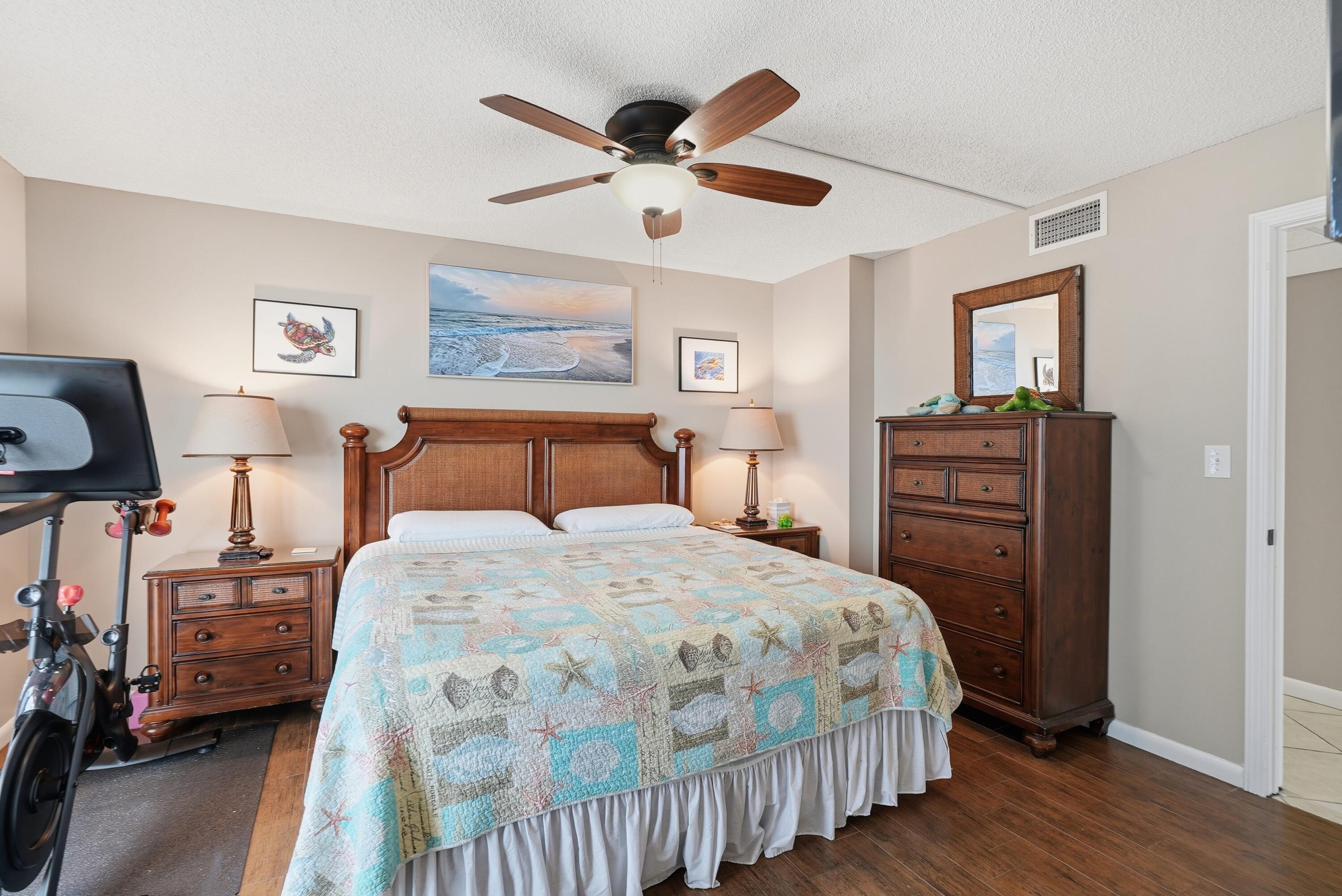 11619 Front Beach Road, Unit 212 Panama City Beach, FL 32407 - Photo 26 of 63 a bedroom with bed and wooden floor