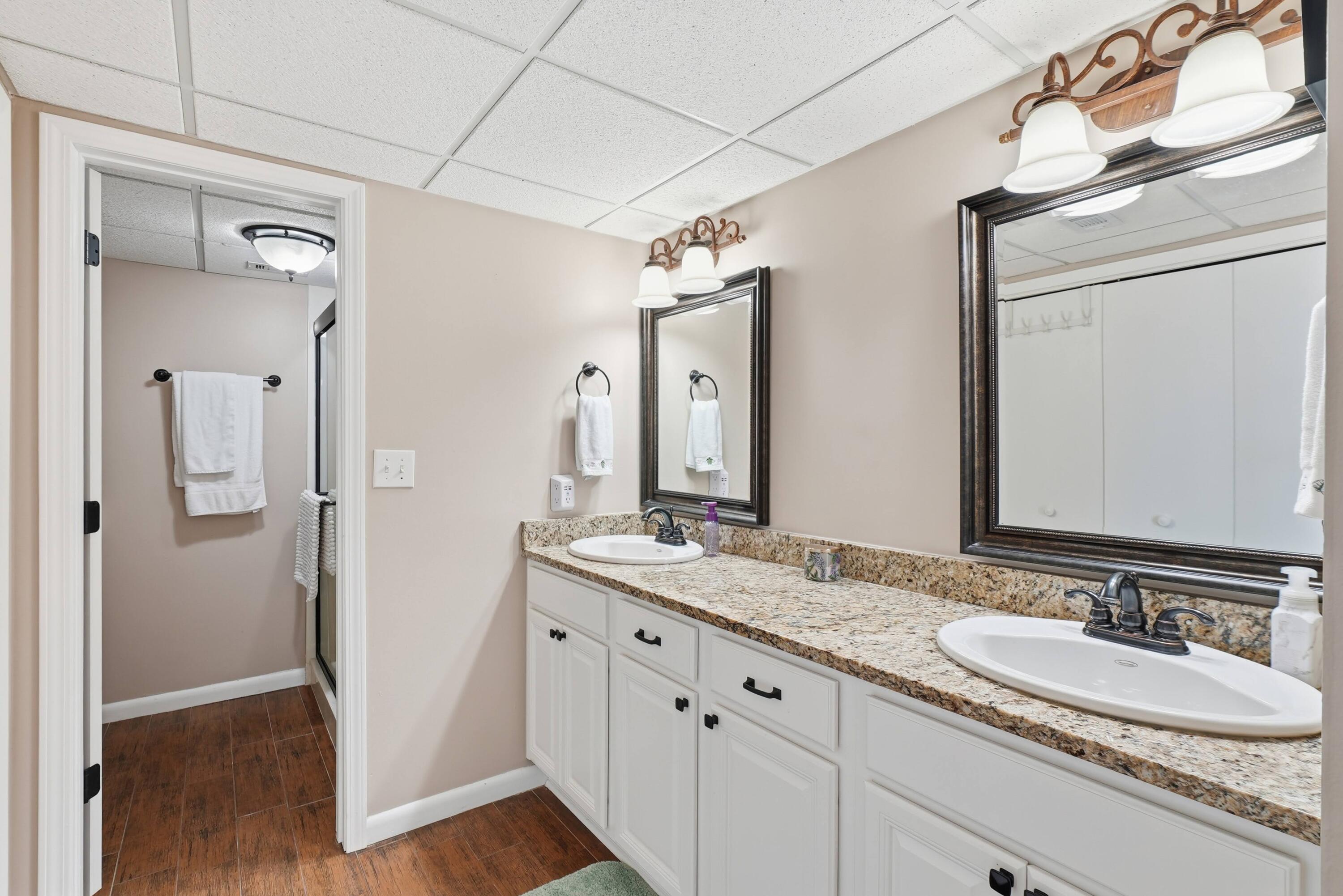 11619 Front Beach Road, Unit 212 Panama City Beach, FL 32407 - Photo 27 of 63 a bathroom with a granite countertop double vanity sink and mirror