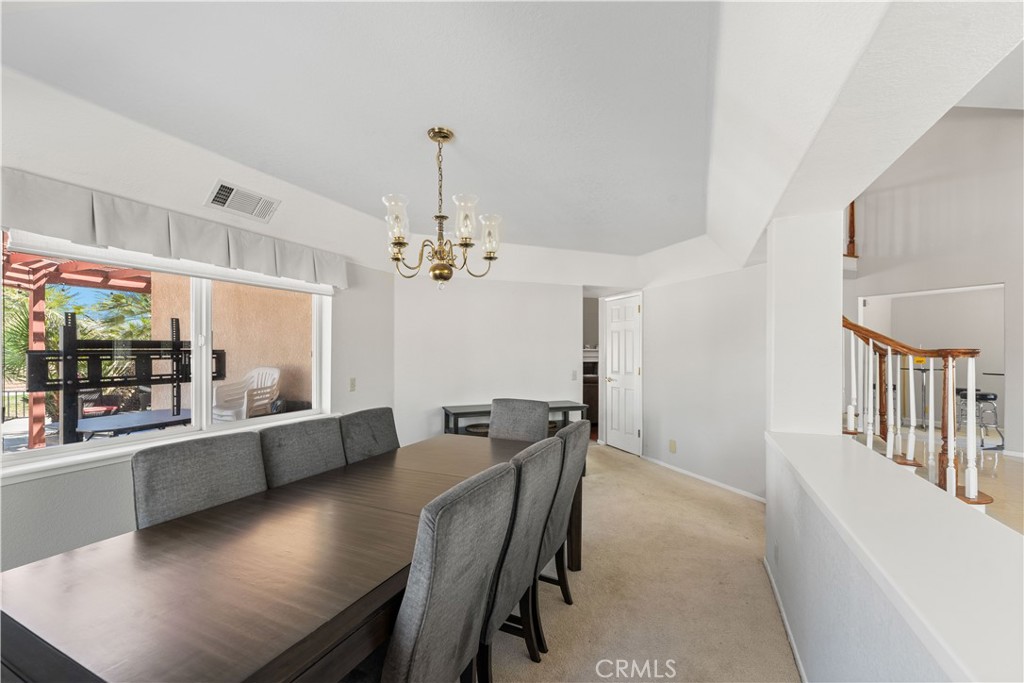 41058 Carmel Road Palmdale, CA 93551 - Photo 16 of 68 a view of a dining room with furniture window and wooden floor