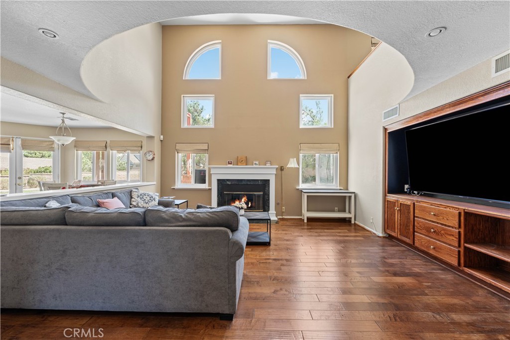 41058 Carmel Road Palmdale, CA 93551 - Photo 17 of 68 a living room with furniture a flat screen tv and a fireplace