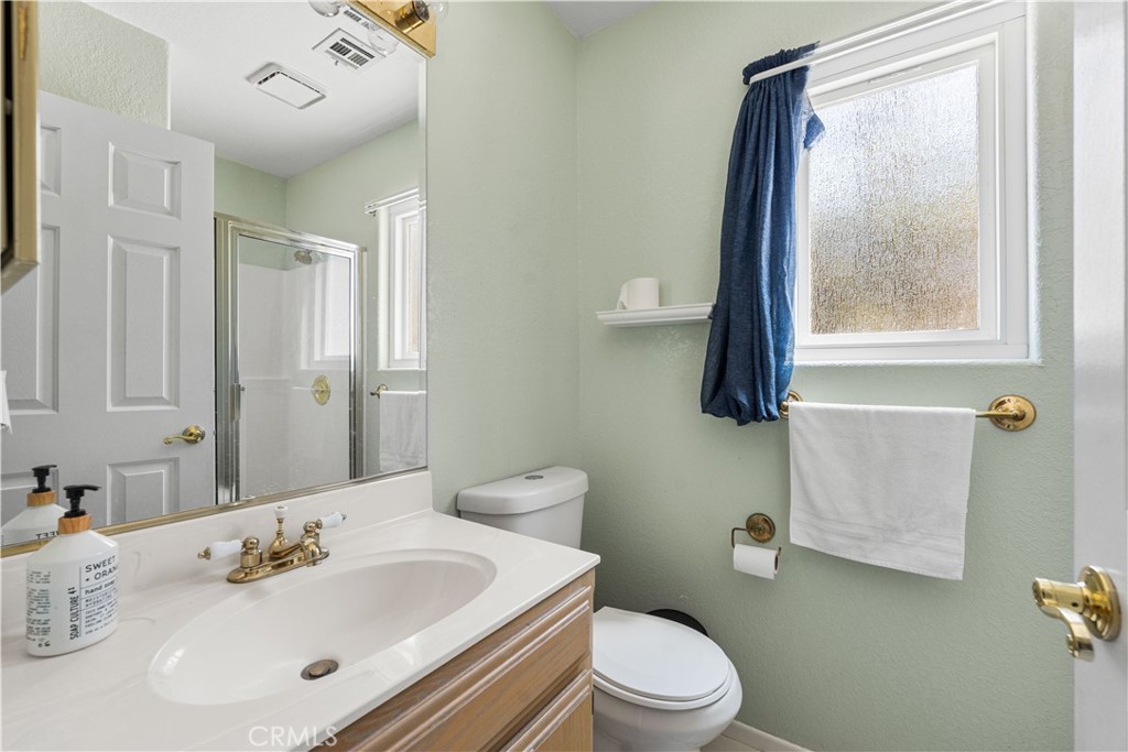 41058 Carmel Road Palmdale, CA 93551 - Photo 27 of 68 a bathroom with a sink mirror vanity and toilet