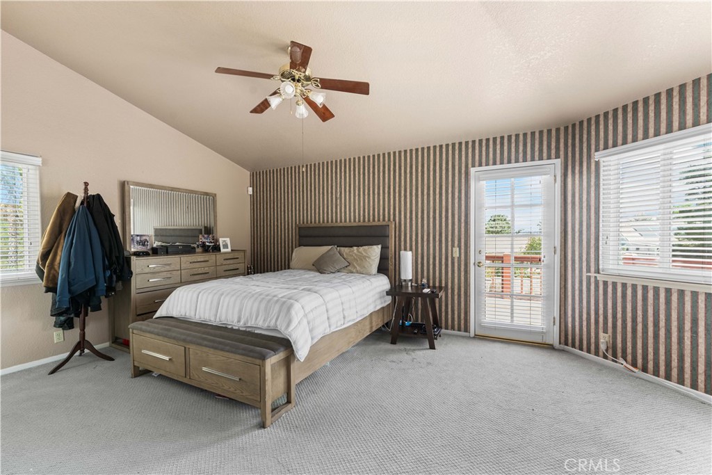 41058 Carmel Road Palmdale, CA 93551 - Photo 32 of 68 a spacious bedroom with a bed and a walk in closet