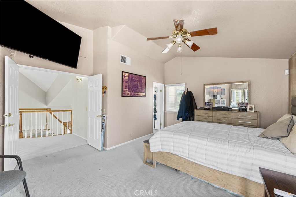 41058 Carmel Road Palmdale, CA 93551 - Photo 33 of 68 a bedroom with a bed and a flat screen tv